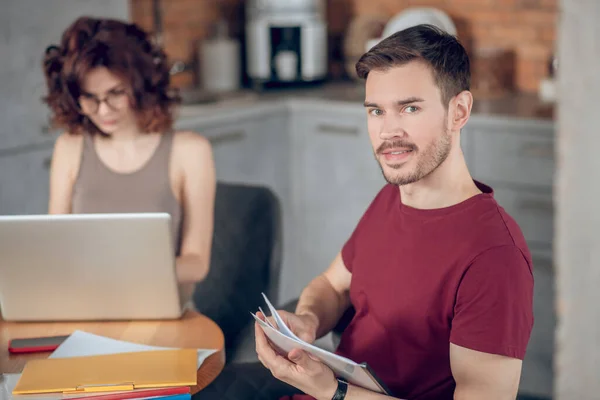 Young professionals working together and looking interested — Stock Photo, Image