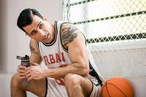 Young man with tatoo resting after a workout — Stock Photo, Image