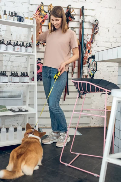 Menina bonito com seu cão passar o tempo em uma loja de animais — Fotografia de Stock