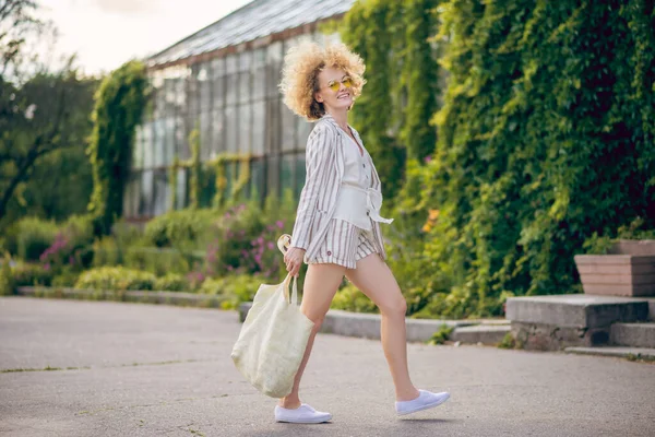 Smal söt ung kvinna med eko väska promenader på gatan — Stockfoto