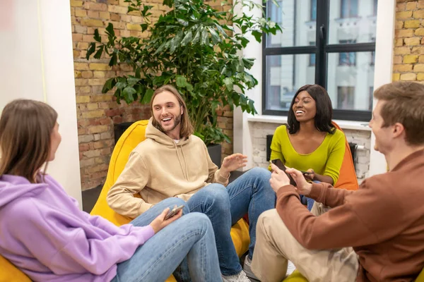 Group of young leaders having fun communicating in office