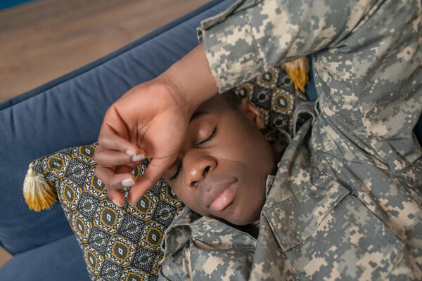 Face of young military sleeping in home