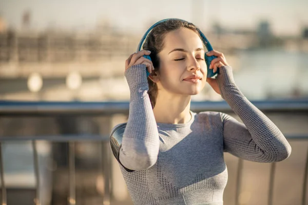 Waist up picture of a girl in headphones looking enjoyed — Stok fotoğraf