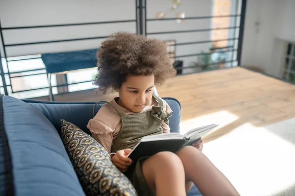 Komoly kis afro-amerikai lány könyvet olvas — Stock Fotó