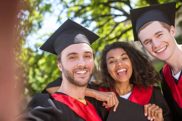 A group of graduates spending time together and feeling united — Stock Photo, Image