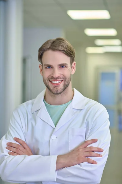 Smiling man in white robe indoors — Stock Photo, Image