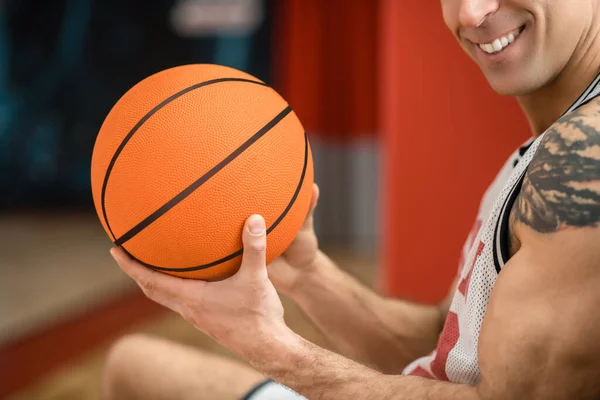 Close up picture of a sportsman with a ball in hands — Stock Photo, Image