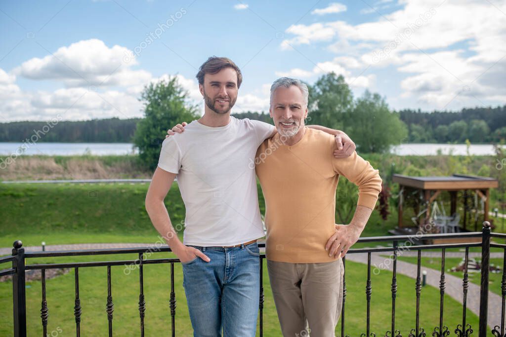 Dad and son spending weekend at the country side and looking enjoyed