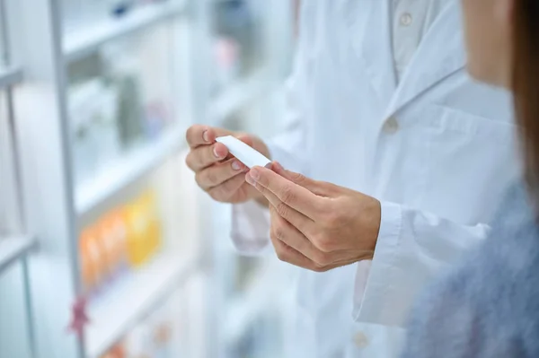 Farmacéutico consultor manos sosteniendo tubo pequeño — Foto de Stock