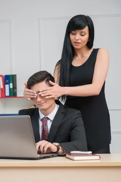 Businesswoman closing colleague eyes in office — Stock Photo, Image