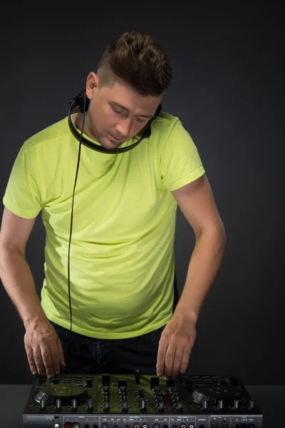 Dj at work isolated on dark grey background — Stock Photo, Image