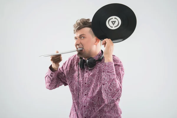 DJ biting vinyl record — Stock Photo, Image