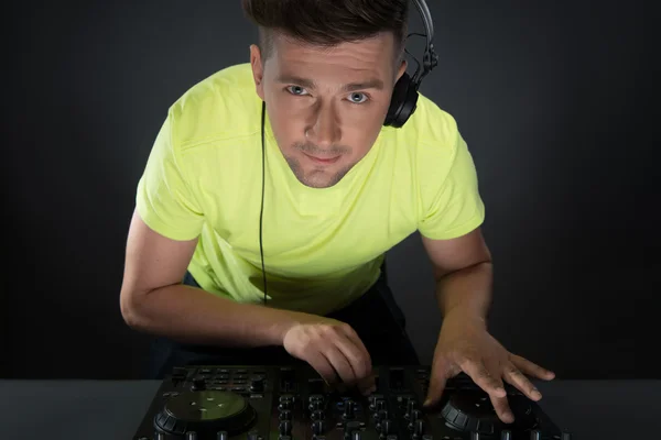 Dj at work isolated on dark grey background — Stock Photo, Image