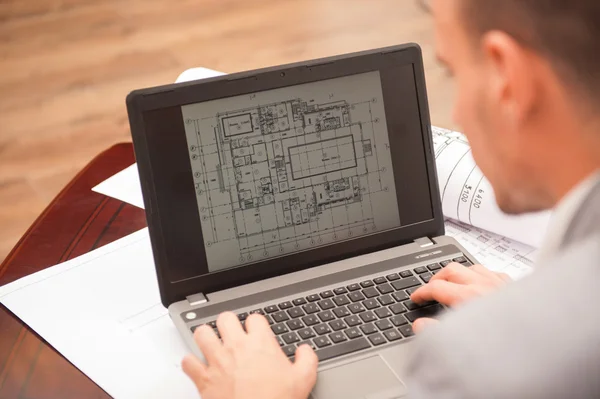 Close-up portrait of laptop with blueprints Royalty Free Stock Photos