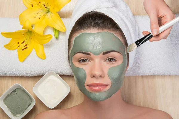 Girl applying facial cream mask — Stock Photo, Image
