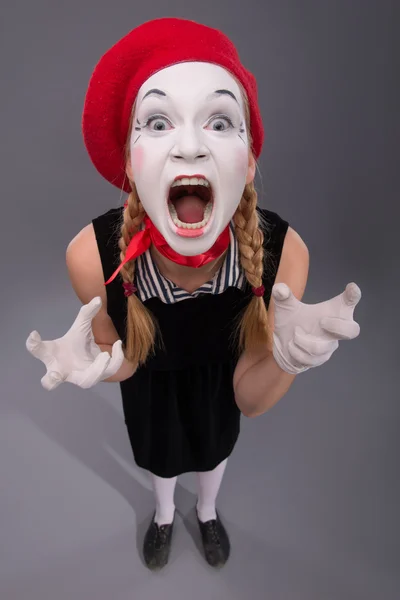 Portrait of female mime in red head and with white face isolated — Stock Photo, Image