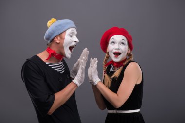 Portrait of funny mime couple with white faces and emotions clipart