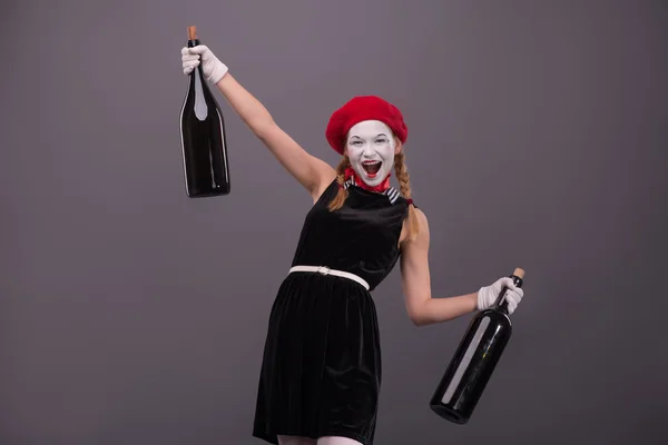 Portrait of young mime girl holding big bottles in her hands iso — Stock Photo, Image