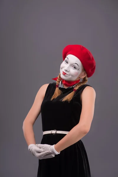 Waist-up portrait of young mime girl showing something — Stock Photo, Image