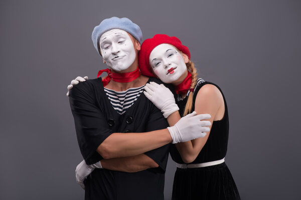 Portrait of funny mime couple with white faces and emotions isol