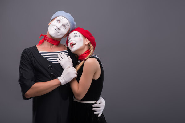 Portrait of funny mime couple with white faces and emotions isol