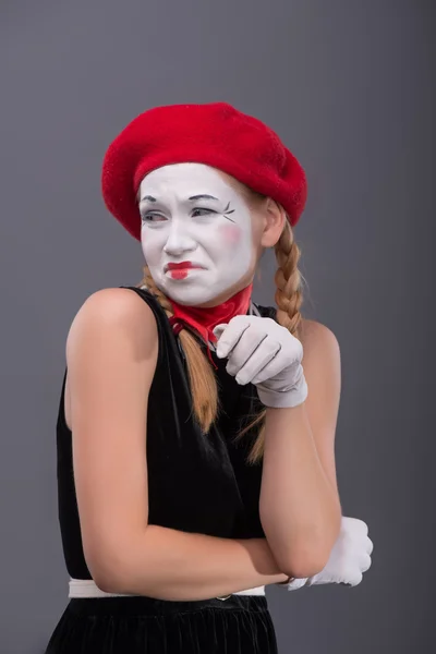 Waist-up portrait of young mime girl showing something — Stock Photo, Image