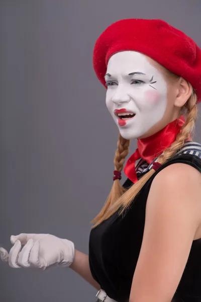 Waist-up portrait of young mime girl showing something — Stock Photo, Image