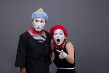 Portrait of sad mime couple crying isolated on grey background clipart