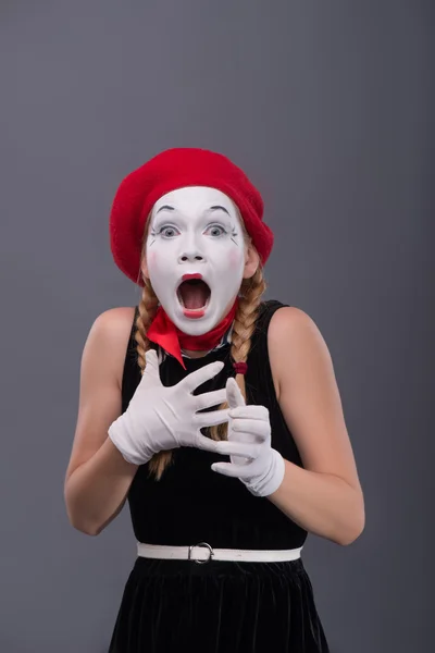 Waist-up portrait of young mime girl showing something — Stock Photo, Image