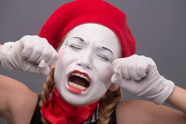 Waist-up portrait of young mime girl showing something — Stock Photo, Image