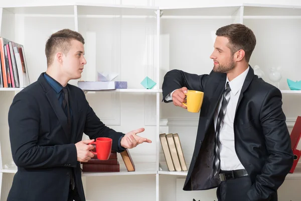 Two businessmen in suits having a coffee-break — Stock Photo, Image