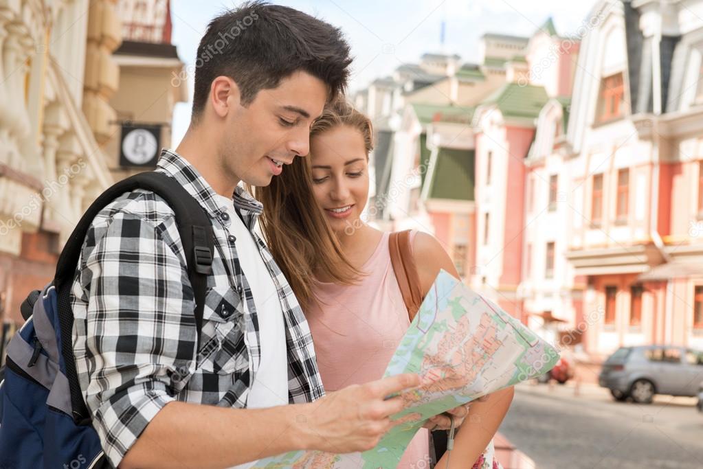 Couple of tourists holding a map