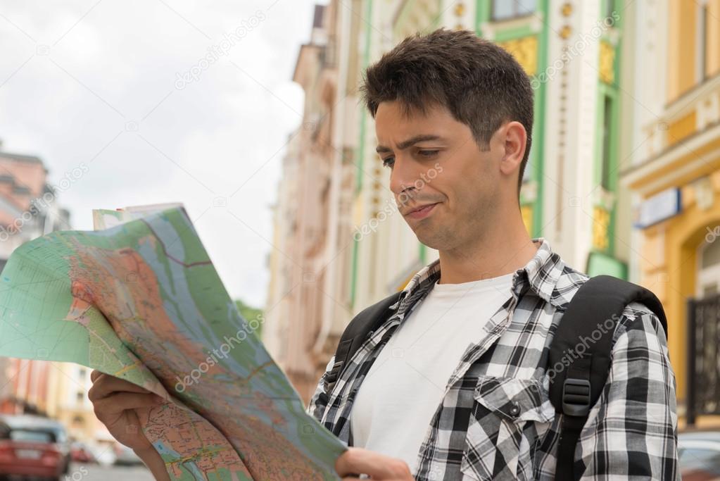 Male traveler looking at the map