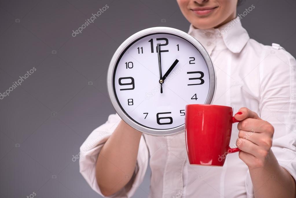 Portrait of girl holding a big clock