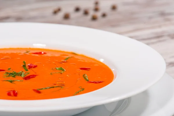 Picture of cold tasty tomato soup gazpacho with species on the w — Stock Photo, Image