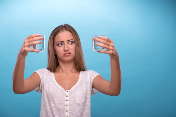 Girl comparing quality of the water — Stock Photo, Image