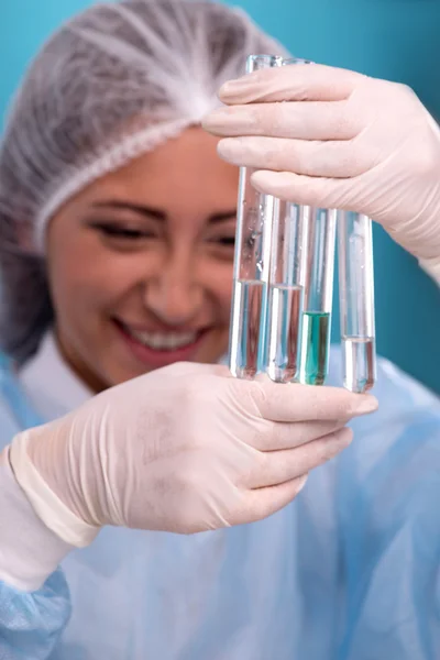 Portrait of young female scientist wearing overall in laboratory — Stock Photo, Image