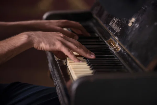 Close-up picture of hands of a musician playing on the black anc — Stock Photo, Image