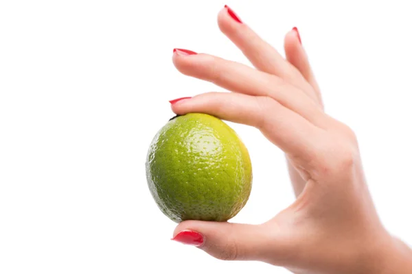 Woman's hand with  green lime. — Stock Photo, Image