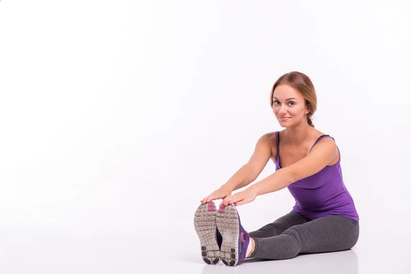 Healthy young sportswoman does the exercises — Stock Photo, Image