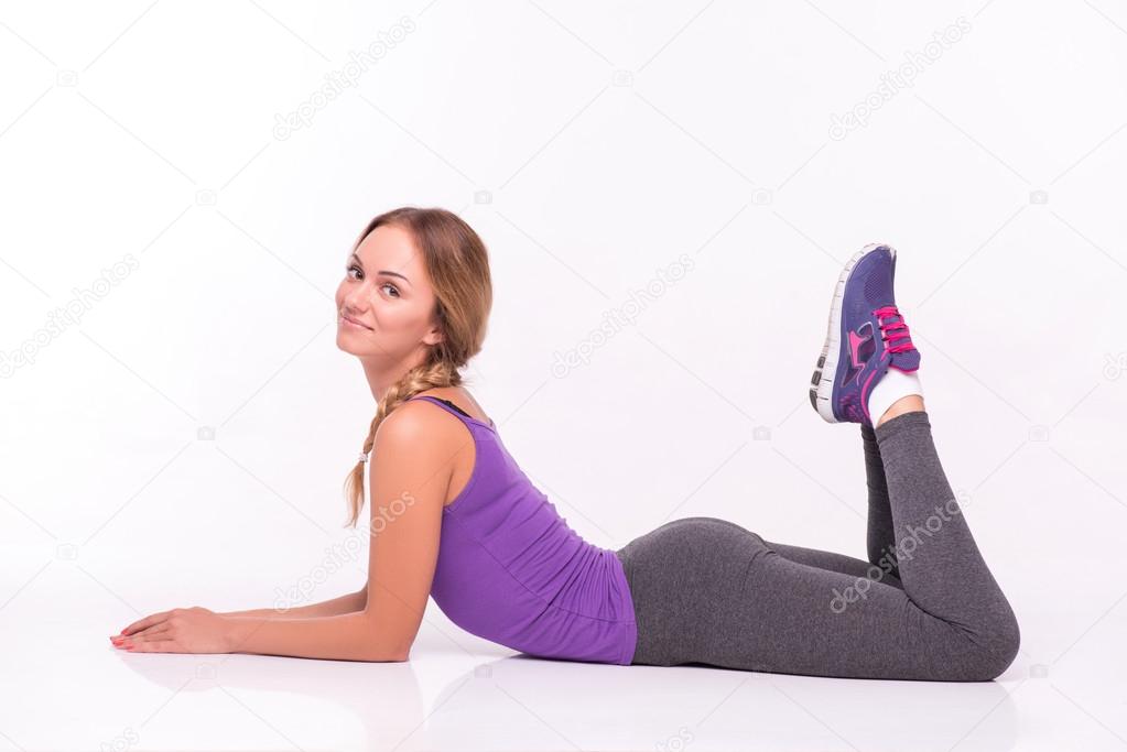 Healthy young sportswoman does the exercises