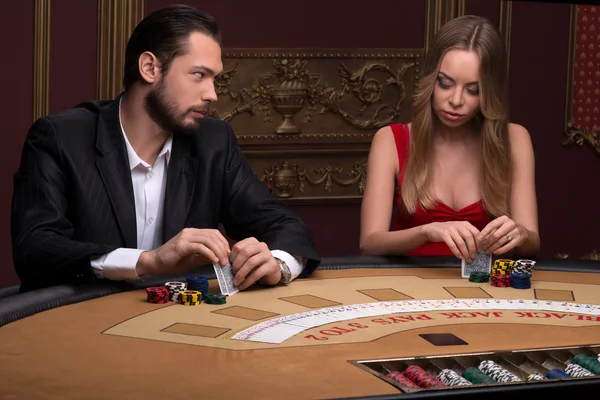 Handsome  man and beautiful woman in casino — Stock Photo, Image