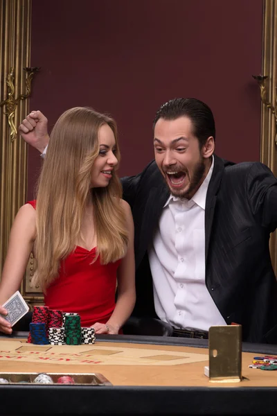 Handsome man and beautiful woman in casino — Stock Photo, Image