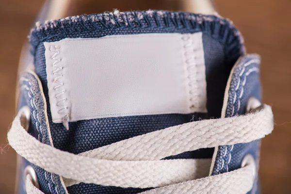 Multicolored youth gym shoes on floor — Stock Photo, Image