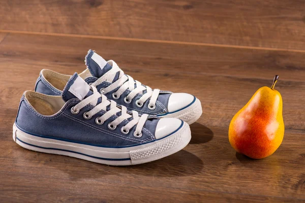 Multicolored youth gym shoes on floor — Stock Photo, Image