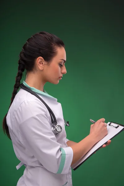 Woman doctor writing — Stok fotoğraf