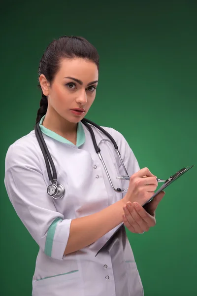 Woman doctor writing — Stock Photo, Image