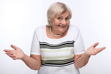 Closeup of elderly woman shrugging shoulders