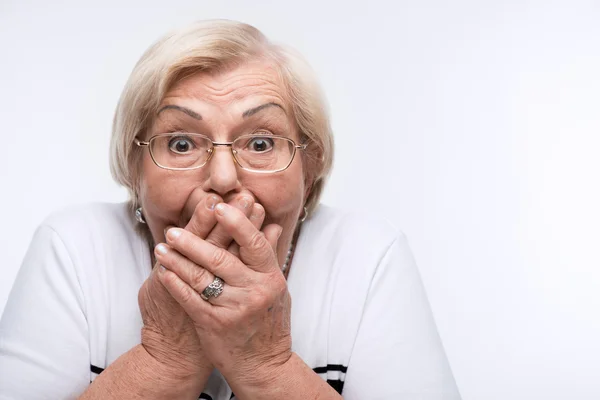 Elderly woman closes her mouth, ears and eyes with hands — Stock Photo, Image