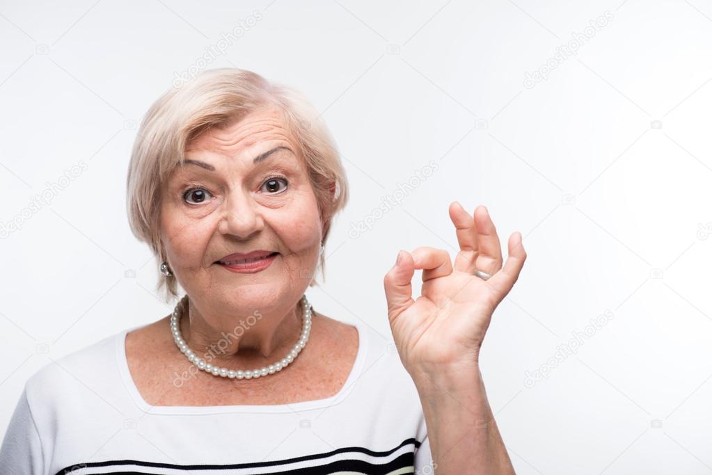 Elderly lady showing OK sign